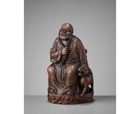 A BAMBOO ‘ASITA AND LUDUAN’ FIGURE, EARLY QINGChina, 17th-18th century. The ‘Long Eyebrow Luohan’ seated on a craggy rock, we
