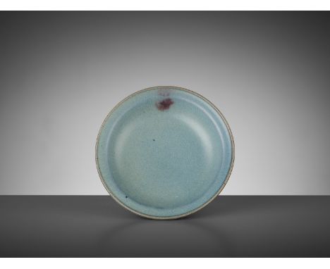 A JUNYAO PURPLE-SPLASHED DISH, YUANChina, 1279-1368. The shallow rounded sides rising from a short ring foot to a wide everte