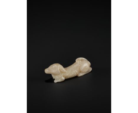 A PALE GRAY JADE FIGURE OF A RECUMBENT HOUND, TANG TO SONG DYNASTYChina, 618-1279. The translucent stone of a pale gray tone 