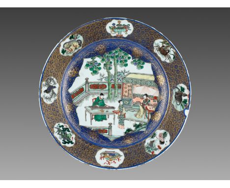 A LARGE POWDER-BLUE AND FAMILLE VERTE DISH, KANGXIChina, 1662-1722, ca. 1680. Painted to the central lobed foliate roundel wi