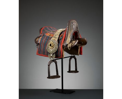 A TIBETAN-CHINESE SHAGREEN AND LACQUERED WOOD SADDLE WITH IRON FITTINGS, QINGChina, late 18th to early 19th century. Of typic