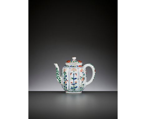 A WATERMELON-SHAPED WUCAI TEAPOT AND COVER, KANGXI PERIODChina, 1662-1722. The lobed ovoid body rising from a short straight 