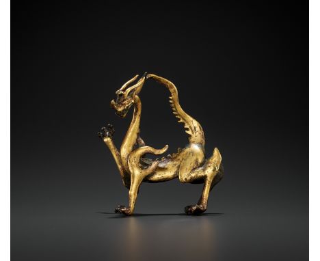 A RARE GILT BRONZE FIGURE OF A DRAGON, TANG DYNASTYChina, 618-907. Finely cast striding in suspended movement with the right 
