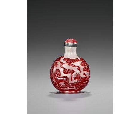 A RUBY-RED OVERLAY SNOWFLAKE GLASS ‘HORSES AND PINE’ SNUFF BOTTLE, QING DYNASTYChina, 1750-1850. Carved in relief through the