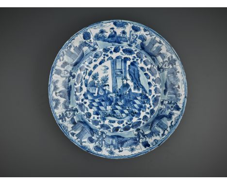 A LARGE BLUE AND WHITE ‘COURT OFFICIAL AND ATTENDANT’ DISH, WANLIChina, 1573-1620. Painted to the interior with a central rou