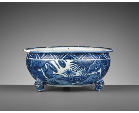 A BLUE AND WHITE ‘BUDDHIST LION’ TRIPOD CENSER, WANLI PERIODChina, 1573-1620. The compressed globular body supported on three