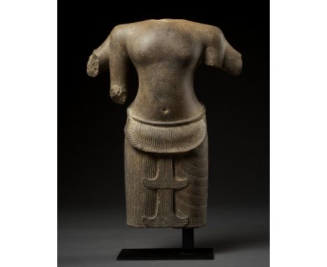 A SANDSTONE TORSO OF A FOUR-ARMED DEITY, ANGKOR PERIODKhmer Empire, 12th-13th century. Very finely carved with a graceful out