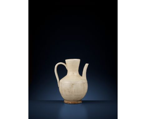 A SLIP-COVERED LOBED EWER, LIAO TO SONG DYNASTYChina, 907-1279. The body finely molded with six lobes, supported on a short s