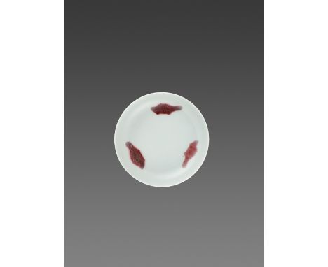 A COPPER-RED ‘THREE-FISH’ DISH, YONGZHENG MARK AND PERIODChina, 1723-1735. The gently rounded sides rising from a short ring 