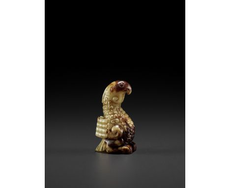 A YELLOW AND RUSSET JADE FIGURE OF A PHOENIX, EASTERN ZHOUChina, 770-475 BC. The semitranslucent stone of an attractive green