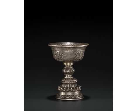 A SILVER REPOUSSE BUTTER LAMP, 19TH CENTURYTibet. The stem bowl with deep sides incised and embossed with four lobed reserves