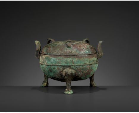 AN ARCHAIC BRONZE RITUAL TRIPOD VESSEL AND COVER, DING, EASTERN ZHOUChina, 4th century BC. The vessel and cover of compressed