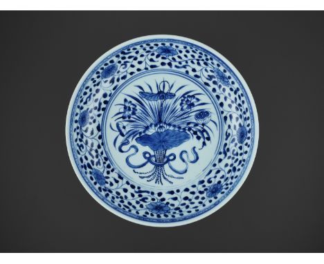A MING-STYLE BLUE AND WHITE ‘LOTUS BOUQUET’ DISH, 18TH CENTURYChina, 1736-1795. The rounded sides rising from a slightly tape