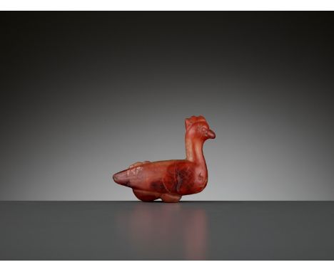 A CARNELIAN ‘ROOSTER’ PENDANT, 1ST MILLENNIUM ADChina. Carved as a rooster with a pierced three-pointed comb, eyes, beak, win