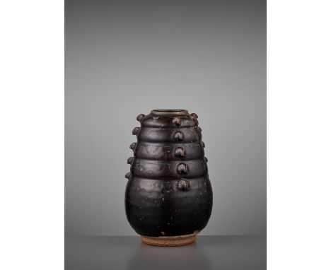 A BROWN-GLAZED JAR, EARLY NORTHERN SONG DYNASTYChina, 10th-11th century. The tapering jar molded with five horizontally lobed