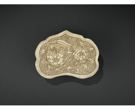 A CIZHOU RUYI-SHAPED SGRAFFIATO ‘PEONY’ PILLOW, SONG DYNASTYChina, 960-1279. Of ruyi-head outline, the top boldly carved thro