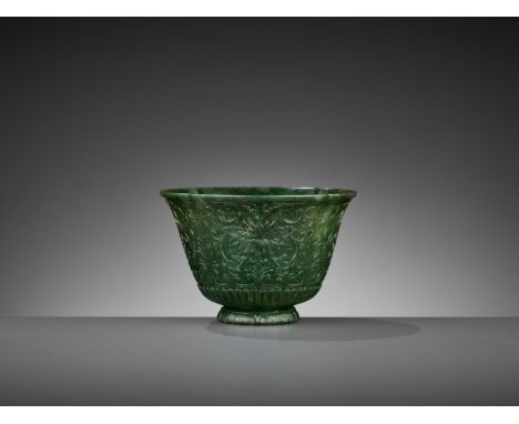 A LOBED SPINACH-GREEN JADE ‘CHRYSANTHEMUM’ BOWL, QINGChina, 18th century. The deeply lobed sides rounded about the splayed fo