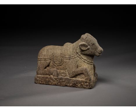 A CHAM GRANITE SCULPTURE OF NANDIChampa, 10th - 14th century. The caparisoned holy bull powerfully carved in a recumbent posi