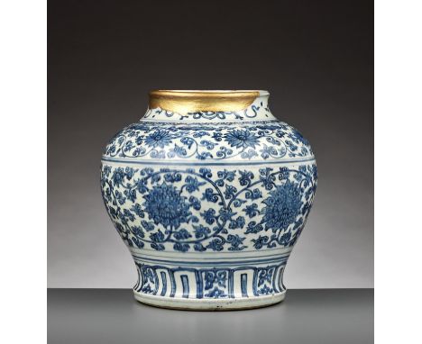 A BLUE AND WHITE ‘LOTUS’ JAR, GUAN, MING DYNASTYChina, circa 1500. The baluster body rising from a slightly tapering foot to 