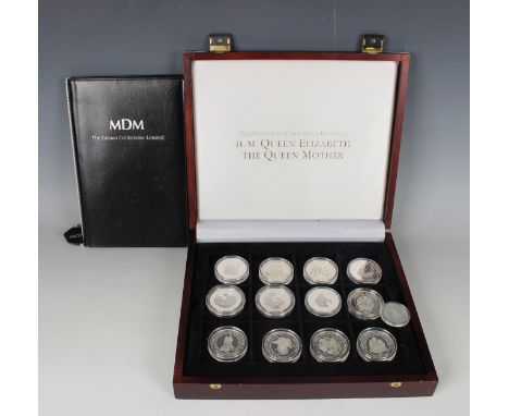 A collection of twenty-four MDM silver crown-size coins commemorating HM Queen Elizabeth the Queen Mother, with a smaller sin