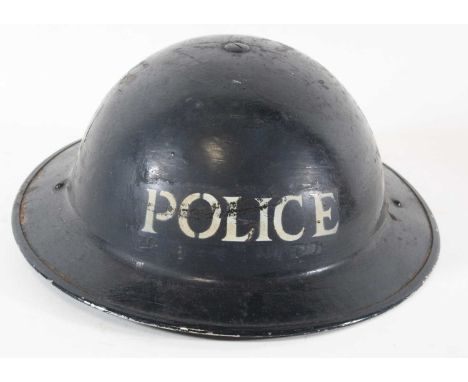 A WW II Brodie pattern Home Guard helmet, Police issue, having a black leather liner and canvas chin strap marked BMB (Briggs