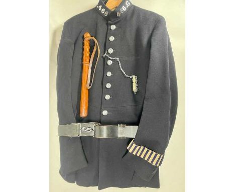 A blue cloth high necked single breasted Police uniform with blue striped arm bands stamped inside 6/0 7A FWH to fit size 6 f
