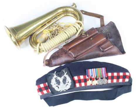 A collection of miscellaneous militaria to include a Seaforth Highlanders glengarry affixed with miniature WW II 1939-1945 St