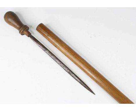 An early 20th century customs officer's sword stick, having a beech shaft housing a 27cm steel blade on a turned beech handle