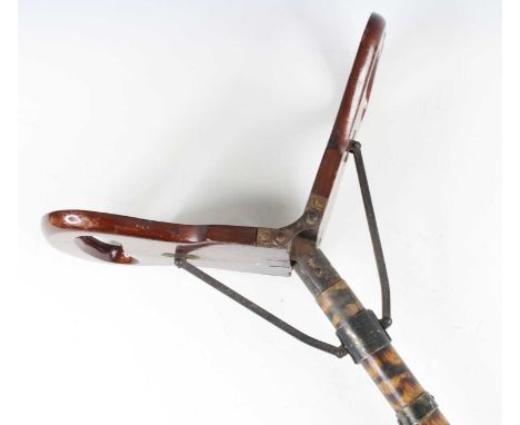 An early 20th century shooting stick, having a folding mahogany seat on a simulated bamboo beech column, h.89cm.