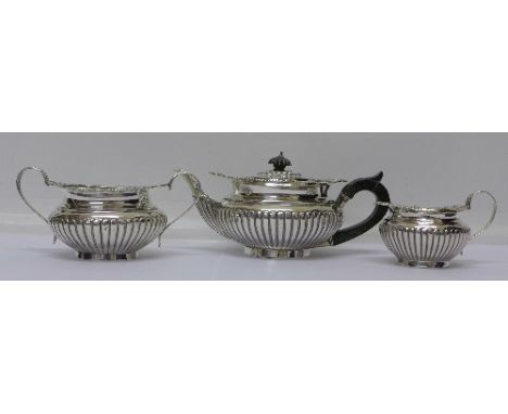 A matched three piece silver tea service, tea pot and cream hallmarked Birmingham 1899 by George Unite, the sugar hallmarked 