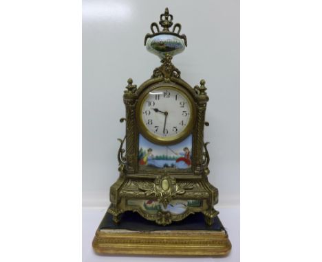 A brass cased clock with enamel decoration, on base