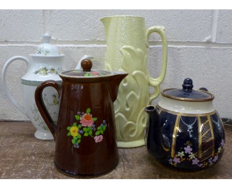 A Bourne Denby water jug, a Royal Doulton Tonkin coffee pot, a Wade teapot, spout a/f and a jug