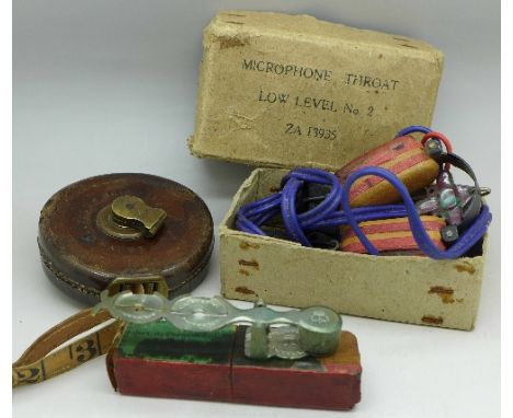 A tape measure, Sovereign scales and a throat microphone in box