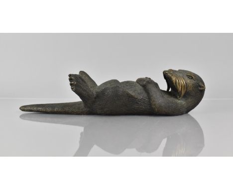 Phil Vanderlei (American) A Bronze Study of an Otter, Modelled Floating on Back with Sea Urchin Held in Paws, Signed and No 4