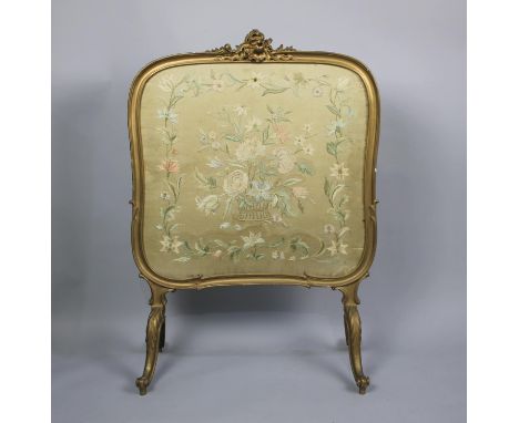 A Gilt Framed Firescreen with Silk Embroidery Under Glass, Scrolled Feet, 64cms Wide 