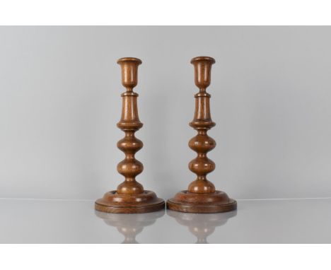 A Pair of 19th Century Treen Turned Oak Candlesticks with Bobbin Turned Shafts over Circular Bases, 28cms High 