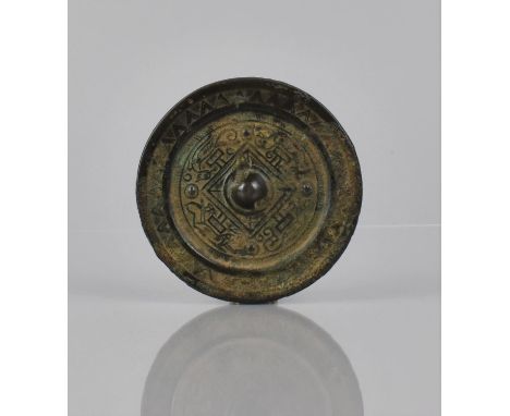 A Chinese Bronze Mirror, Possibly Han Dynasty, with Central Knop and Relief with Geometric Design and Symbolic Constellation,