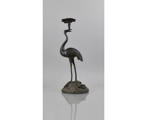 A Japanese Bronze Candlestick in the Form of Crane Holding Lily Sprig with Candle Holder in Beak and Set on Stylised Circular