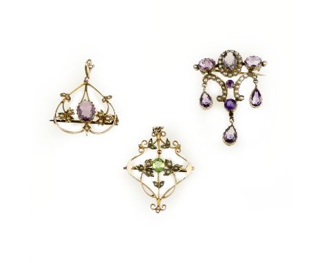 Two gem-set pendant/brooches and another similar brooch, circa 1890Each of open scroll design, one set with an oval-cut perid