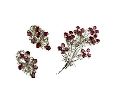 A ruby and diamond demi-parure, mid-20th centuryComprising: a foliate spray design brooch, set with oval-cut rubies and gradu