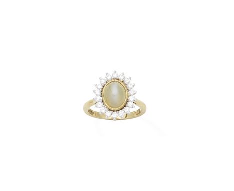 A cat's eye chrysoberyl and diamond cluster ring, 1982Centrally-set with an oval cabochon-cut cat's eye chrysoberyl, within a