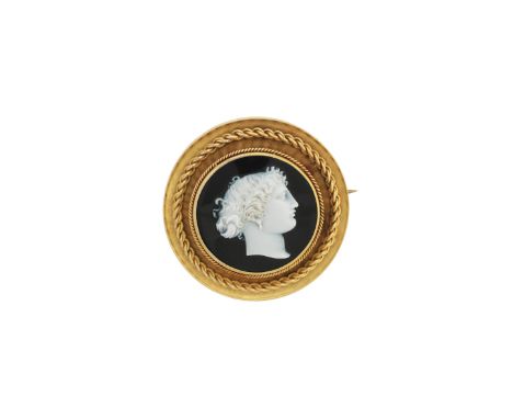 An onyx cameo brooch, VictorianOf circular design, the onyx cameo carved with a classical female portrait profile, within a b