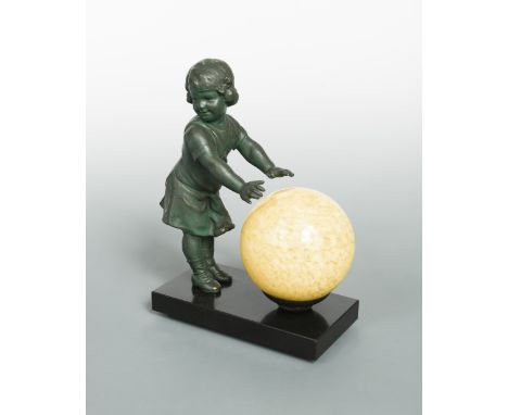 An Art Deco table lamp, modelled as a bronzed spelter girl warming her hands on the glass globe, mounted to a polished slate 