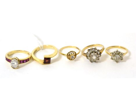 A 9ct gold ruby and cubic zirconia ring, finger size M, a 9ct gold garnet ring, two 9ct gold cluster rings and a ring stamped