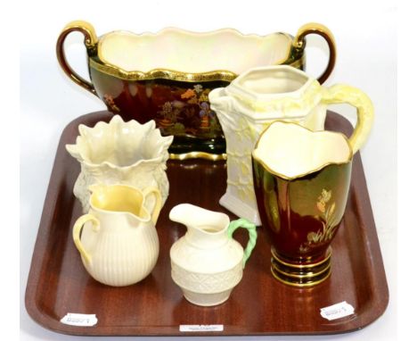 A Beleek foliate decorated jug, cream jug, milk jug and a small planter together with a Carlton ware Rouge Royal planter and 