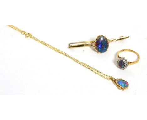 A 9ct gold opal triplet and diamond pendant on chain, chain length 45cm, an opal triplet brooch and an opal triplet ring, fin