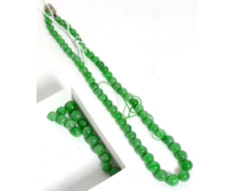 A jade bead necklace, formed of graduated jade beads knotted to an emerald and diamond set clasp, length 40cm, with 15 loose 