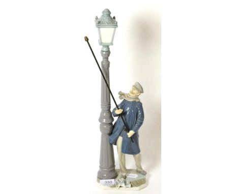 A Lladro figure of a lamp lighter