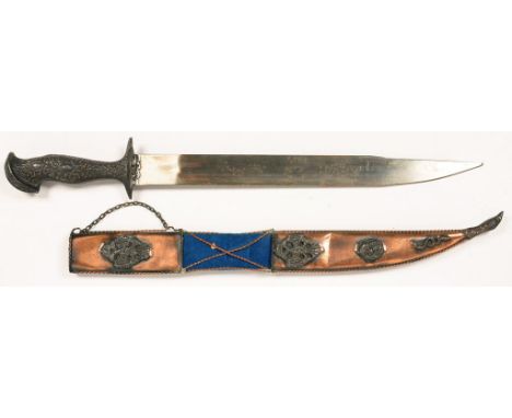 A SOUTH EAST ASIAN KNIFE AND SHEATH WITH SHAPED AND EMBOSSED METAL COVERED HILT, THE COPPER-OXIDISED SHEATH WITH BLUE VELVET 