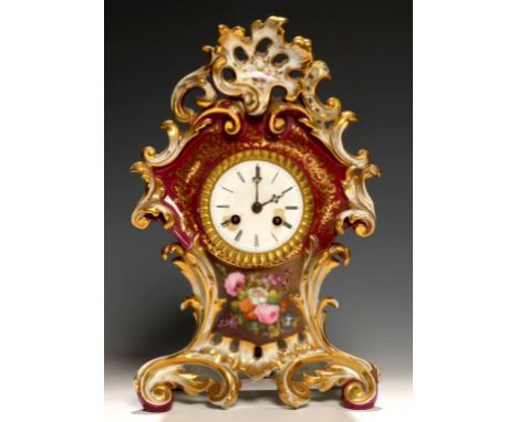 A FRENCH CLARET GROUND PORCELAIN MANTLE CLOCK, C1840,  painted with flowers, the bell striking movement with silk suspension,